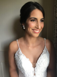 A beautiful dark-haired bride with stunning makeup and hair.