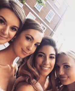 A pretty bride takes a selfie with her pretty bridesmaids.