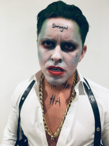 Male with Joker makeup and face paint for Halloween.