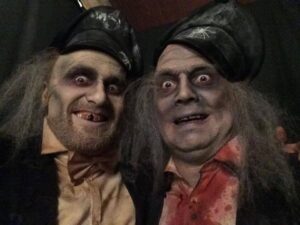 Two men with Dickensian zombie makeup for Halloween.
