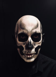 Skull face paint on a man for Halloween.