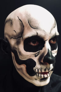 Skull face paint on a man for Halloween.