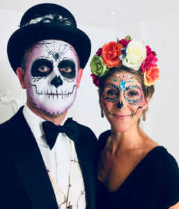 A couple at a party with Halloween makeup.