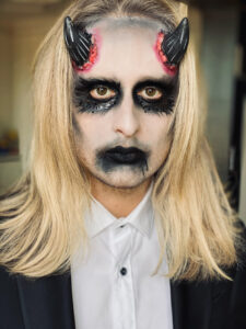 Demon makeup on blonde-haired man.