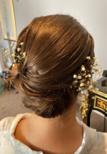 Swept-up bridal hairstyle with accessories.