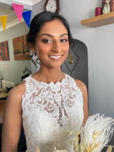 An Asian bride smiling.