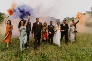 A bridal party with coloured smoke.