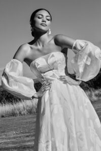 A fashionable bride outdoors in the sun.