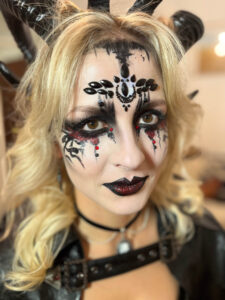 Blonde girl with glam halloween makeup.