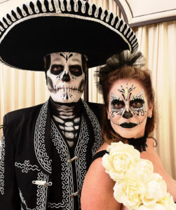 A couple with Day of the Dead Halloween makeup.