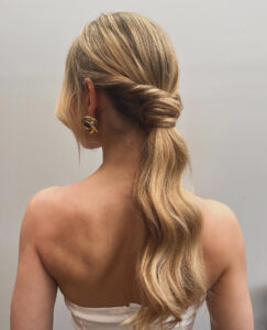 A blonde bridal hairstyle in a cascade effect.