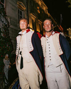 Two French Revolution soldiers in uniform with makeup showing burns and scars to the face.